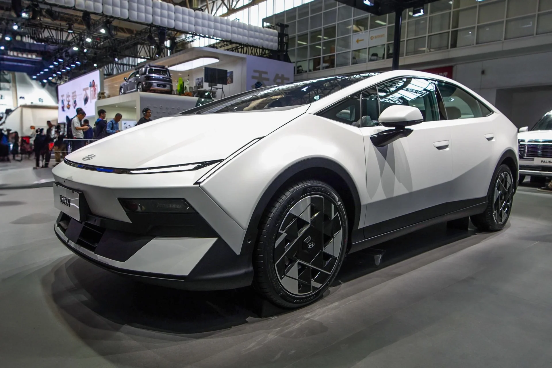 전시회에서 선보인 현대 자동차의 최신 전기차 모델, 세련된 디자인과 독특한 휠 패턴이 특징인 차량.