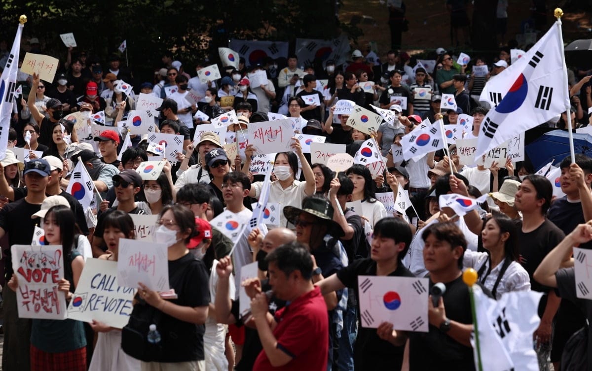 대한민국에서 재선거를 요구하는 대규모 집회, 참가자들이 한국 국기와 피켓을 들고 시위하는 모습.